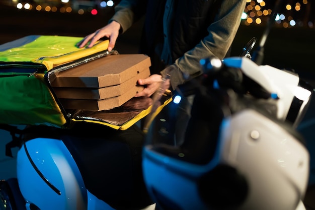 hands courier who takes pizza boxes out bag evening food delivery 307890 5396 1